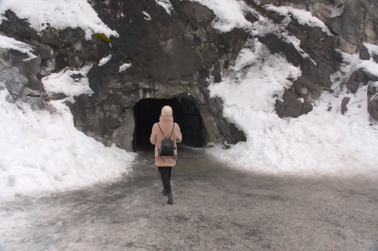 Woman walking into a dark cave