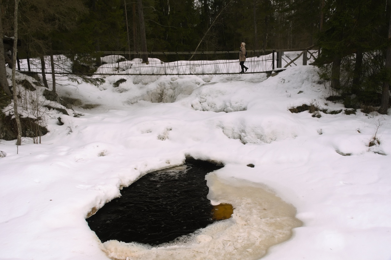 suspension bridge over a frozen waterfall