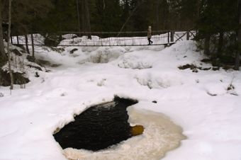 suspension bridge over a frozen waterfall